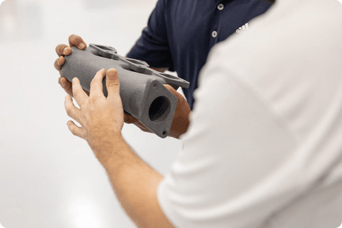 PA 11 3D printed car part Two people holding PA 11 3D printed car part
