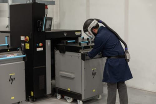 Metal 3D printing employee at the curing station