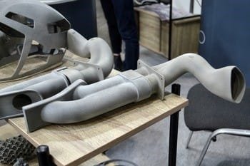 A collection of PA 12 3D printed car parts sitting on a table