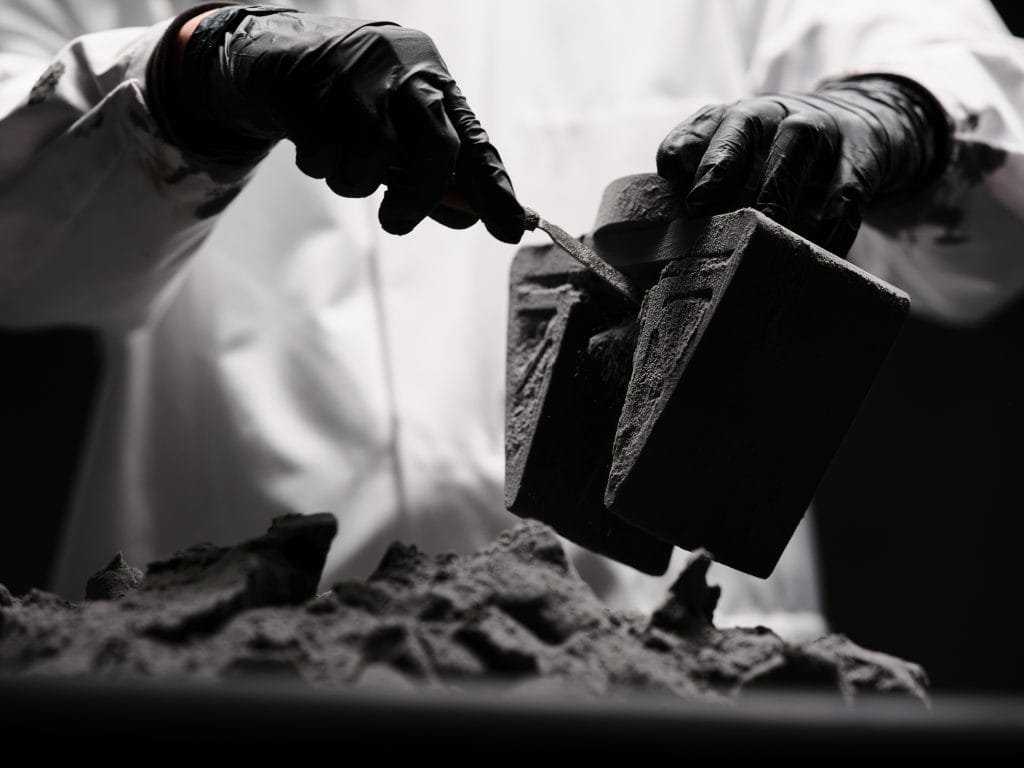 3D printed TPU material gripper Person holding and cleaning powder off of a 3D printed TPU material gripper