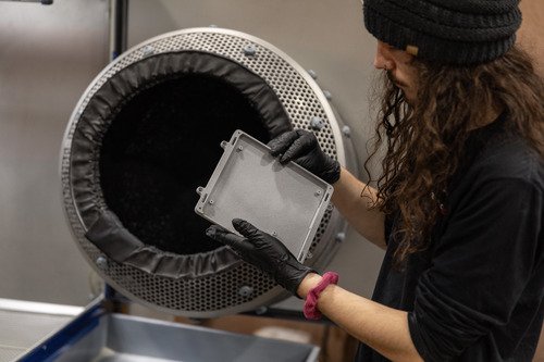 Endeavor 3D employee working a post processing surfacing machine