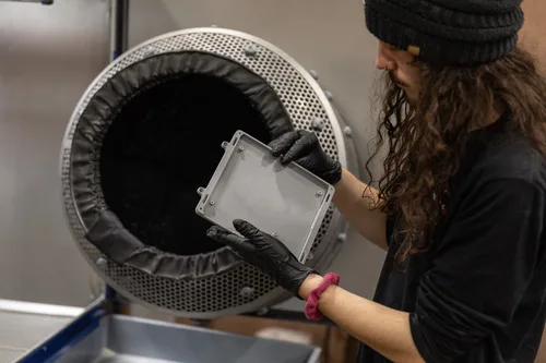 Endeavor 3D employee working a post processing surfacing machine